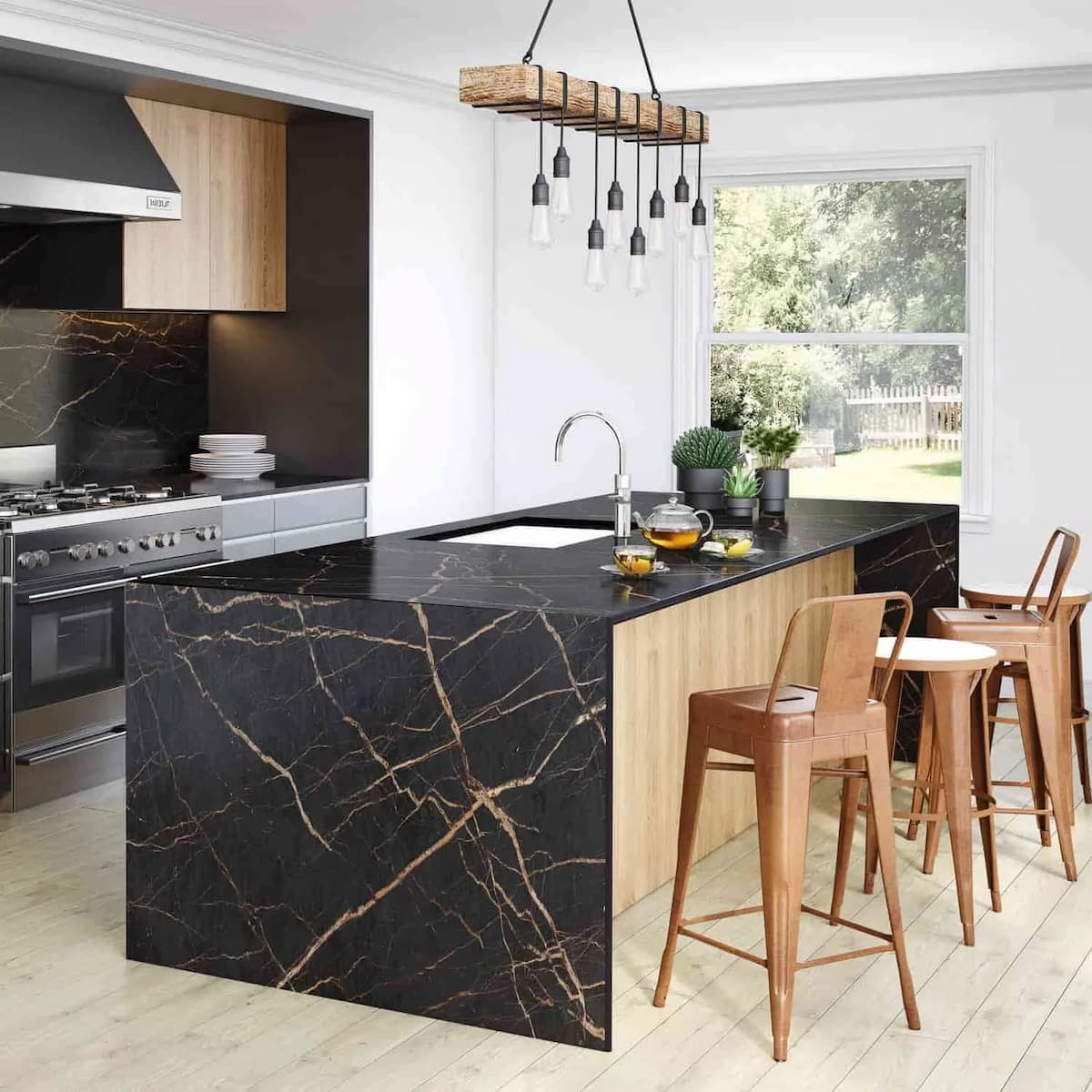 Modern kitchen island with a black marble countertop and waterfall edge.