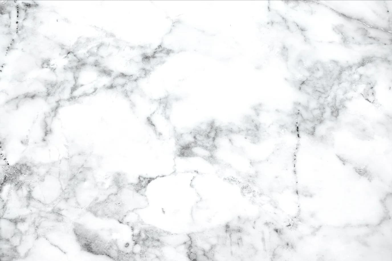 Close-up of a white marble texture with gray veining.