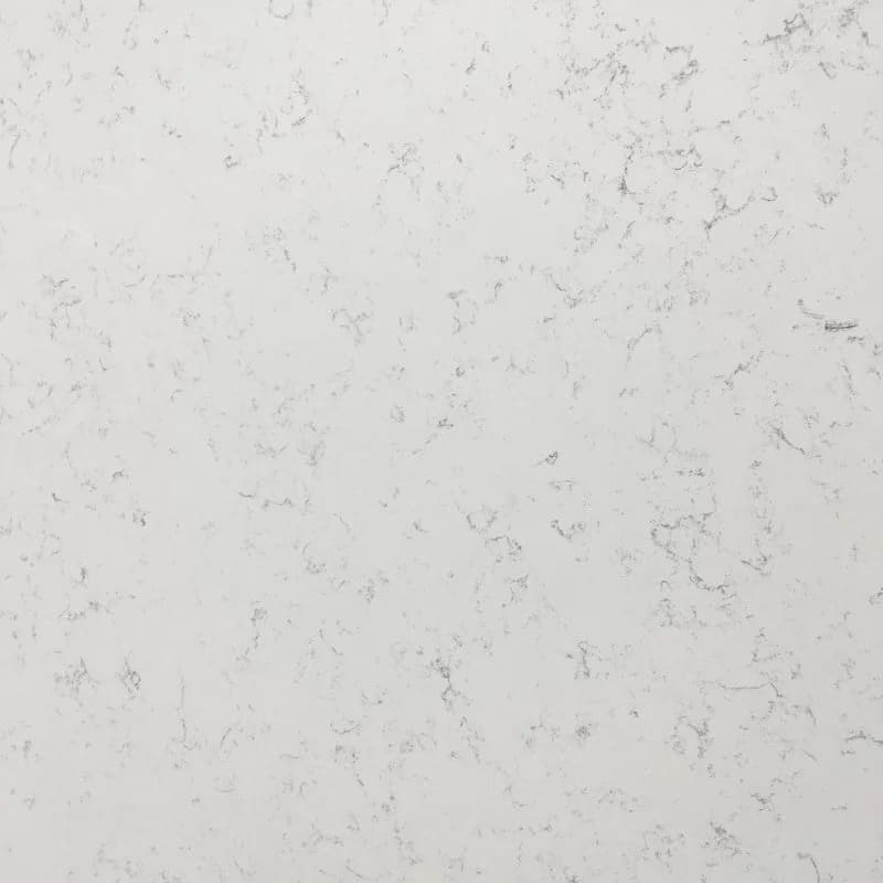 Close-up of a white quartz surface with subtle gray specks and veining.