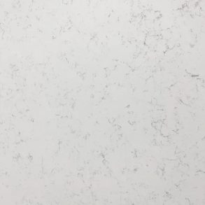 Close-up of a white quartz surface with subtle gray specks and veining.